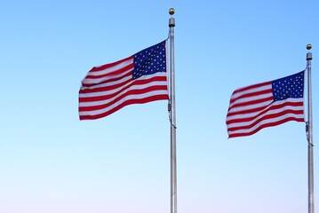 American flag of the United States of America  floating in the sky on a mast