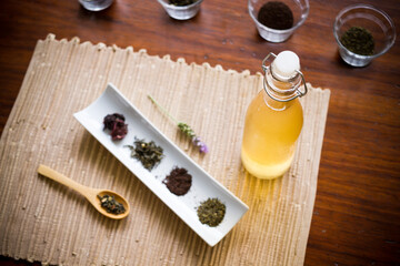 Different teas and flavors to prepare kombucha on a wooden table