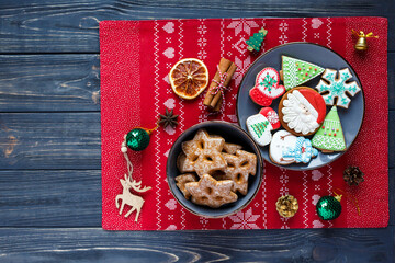 Gray plate with gingerbreads on the table. Holiday, celebration, cooking concept. Close up.  New Year and Christmas cookies