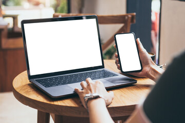 computer,cell phone mockup.hand woman work using laptop texting mobile.blank screen with white background for advertising,contact business search information on desk in cafe.marketing,design