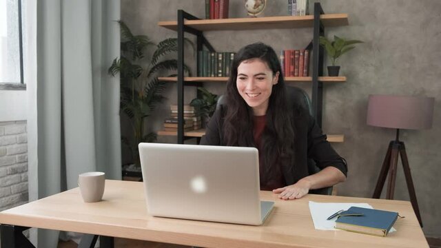 Excited business woman enjoy good news seen on laptop screen in office. Business victory concept. Successful businesswoman shocked with financial results. Happy brunette girl 4k