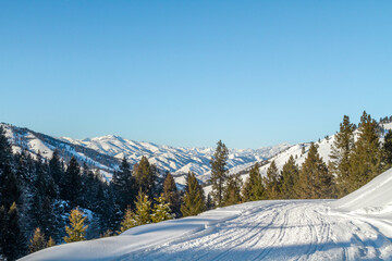 Fototapeta na wymiar A scenic winter scene of a snowmobille trail in the backcountry near Fairfield, Idaho.