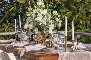 White and Gold Romantic Wedding Table Top Layout Table Spread no people no human tropical location with gold cutlery and scenic view tablescape