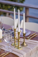 White and Gold Romantic Wedding Table Top Layout Table Spread no people no human tropical location with gold cutlery and scenic view tablescape