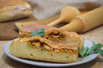 Two pieces of chicken pie on a gray plate.