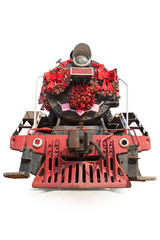 Old steam locomotive with the red decorations isolated on the white background, front view.