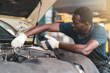 Auto mechanic working in garage, car repair services	