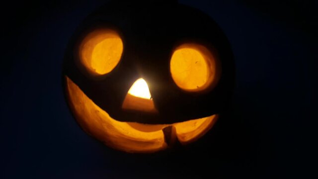 Lighted pumpkin-shaped candle for halloween burning