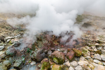 Picturesque view of volcanic landscape, aggressive hot spring, eruption fumarole, gas-steam...