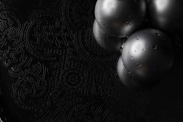 Silver balls on a dark metal surface