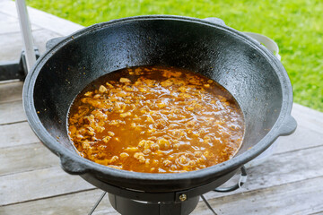 Boiling goulash. Preparation of meat in a cauldron.
