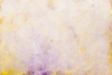 Grunge texture of hand painted purple and yellow watercolor on paper background.
