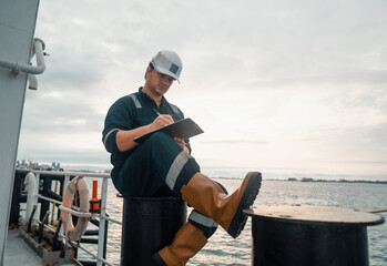 Marine Deck Officer or Chief mate on deck of offshore vessel or ship doing check and filling...