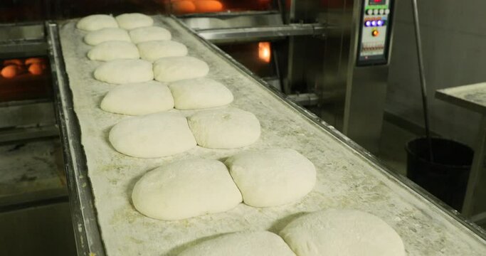 Large Buns Of Bread Ready For Baking Placed On A Deck Oven Loader Or Setter - Bread Making In A Bakery - Closeup Shot