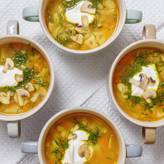 Mushroom soup with in champignons white bowls, top view