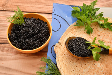 Pancakes with black caviar