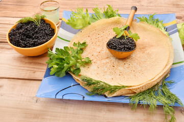 Pancakes with black caviar