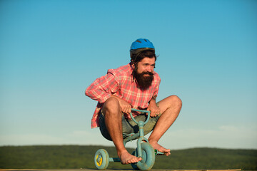 Funny crazy man is riding a bike.
