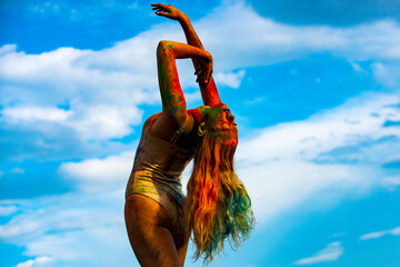 Colorful holi splash on body. Beautiful young woman with amazing body-art color. Color womans body with colorful holi splash.
