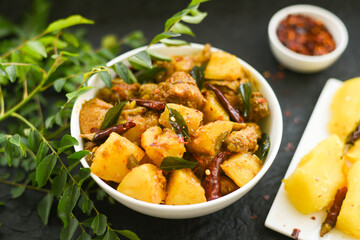 Kappa Biryani Cooked tapioca and spicy meat curry and curry leaf , Cassava root , Mandioca or Aipim,  Kerala special Kappa Puzhukku South Indian food  beef tapioca, India. root vegetable Brazil