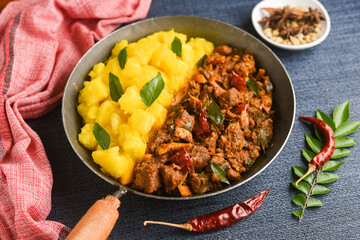Cooked tapioca and spicy meat curry , Cassava root , Mandioca or Aipim,  Kerala special Kappa Puzhukku or Kappa biryani South Indian food  beef tapioca, India. with Fish curry. root vegetable Brazil