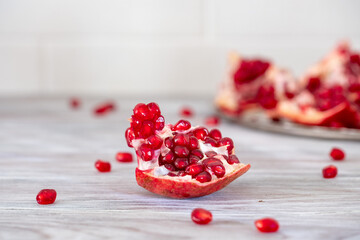 Bright and juicy pomegranate on a wooden table close-up