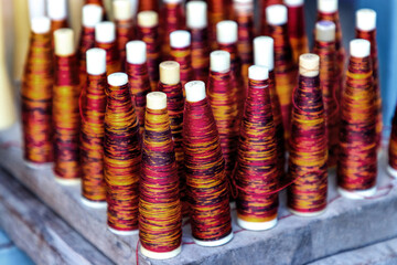 colors of the dyed silk threads in the tube to use in weaving mudmee cloth in Thailand.