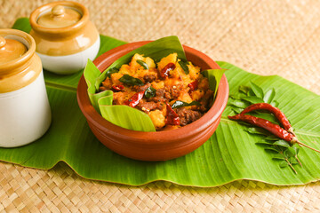 Kappa Biryani Cooked tapioca and spicy meat curry , Cassava root , Mandioca or Aipim,  Kerala special Kappa Puzhukku South Indian food  beef tapioca, India. with Fish curry. root vegetable Brazil