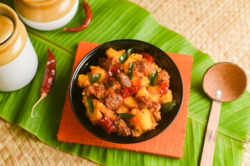 Kappa Biryani Cooked tapioca and spicy meat curry , Cassava root , Mandioca or Aipim,  Kerala special Kappa Puzhukku South Indian food  beef tapioca, India. with Fish curry. root vegetable Brazil