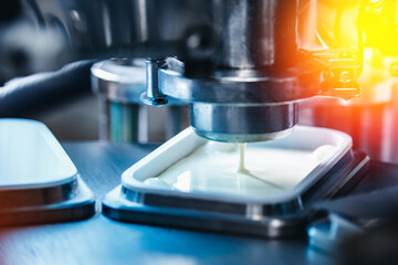 Food production, dairy plant. Automated filling of yoghurt into packages