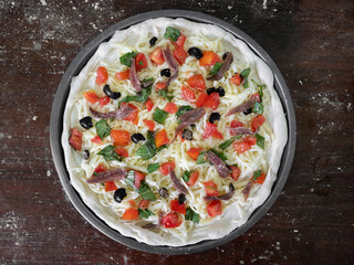 Closeup Pre Baked Anchovy Pizza on Wooden Table