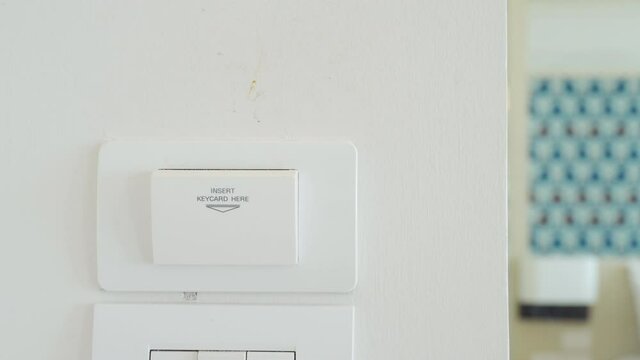 4K Video pull out keycard to shut down electronic appliance in hotel room. Theme for hotel facility and ecology.