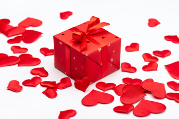 Valentine's day, holiday concept. Gift box and red hearts on a light background. Symbols of love, greeting card design.	