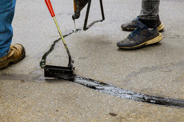 Asphalt road with filled cracks repair, liquid, of the fixed road