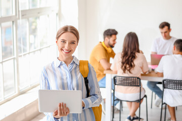 Students with modern devices studying online indoors