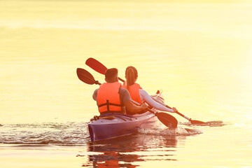 Young couple kayaking in river