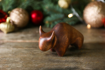 Fototapeta na wymiar Figurine of bull as symbol of year 2021 on wooden table