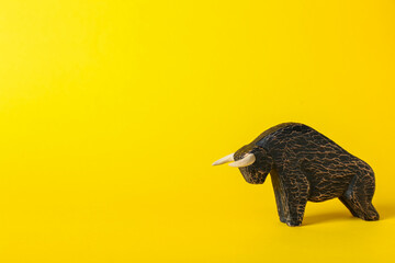 Figurine of bull as symbol of year 2021 on color background