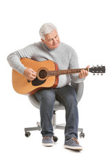 Mature man playing guitar on white background