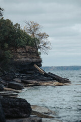 sheer cliff edge with trees and water around