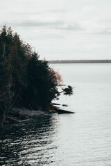 sheer cliff edge with trees and water around