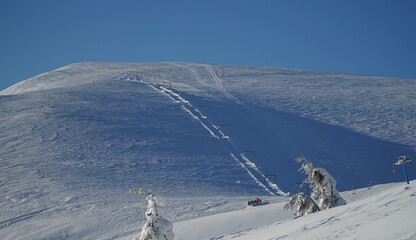 Naklejka na ściany i meble Winter landscape with a ski slope