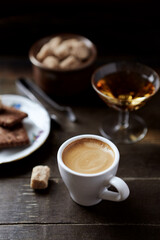 Cup of coffee on rustic wooden background. Close up. 