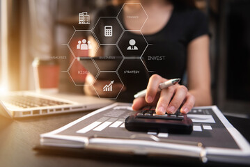 Investors are calculating on calculator investment costs and holding smartphone in hand at home office.