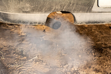 Fuming car exhaust pipe. Environmental pollution.