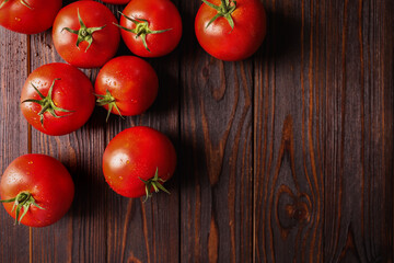 Fresh ripe tomatoes on wooden table, flat lay. Space for text