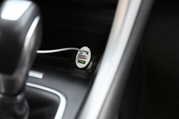 Charging cable connected to plug in car