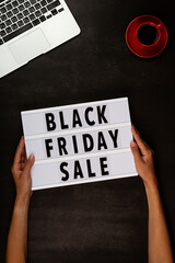 Creative promotion composition for Black friday with laptop on black background. Flat lay, top view, overhead, mockup, template. Minimal abstract background. Online shopping, sale, promo. Web banner