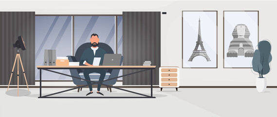 A businessman is working on a laptop in his office. Director's workplace. Laptop, documents, books, loft-style table. Vector.