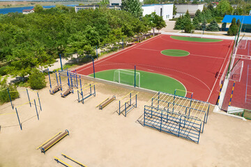 Outdoor sport equipment near football pitch on sunny day, aerial view